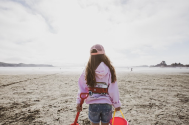 An appropriately-dressed beachgoer takes in the sights at Cox Bay.