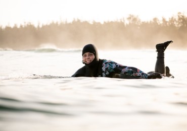 Lydia Ricard surfing out front Long Beach Lodge, on Cox Bay.  Photo by Bryanna Bradley