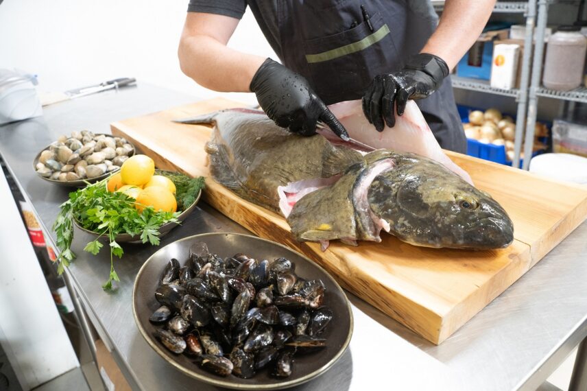 Chef carefully filleting a sustainably sourced Ocean Wise fish.