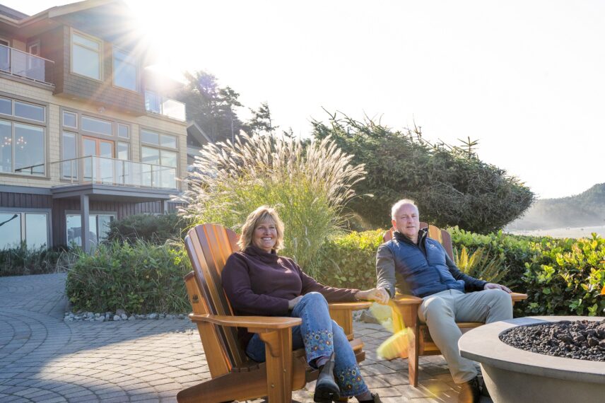 Janet and Brad sitting at the firepits in front of the Lodge