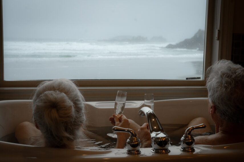 couple in the bathtub overlooking cox bay